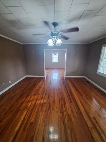 Warm wood flooring stretches through the open doorway into the adjacent dining area.