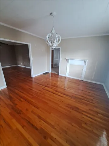 Gleaming hardwood floors and an elegant fireplace mantel define this inviting living space.