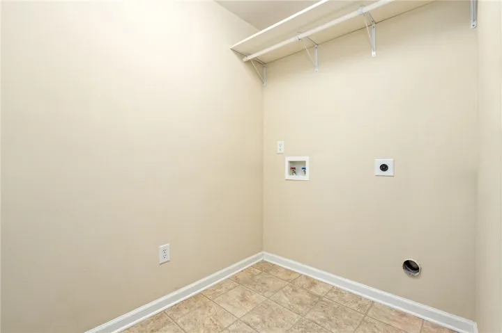 Tiled flooring and built-in shelving define this practical utility​​‌​​​​‌​​‌‌​‌‌​​​‌‌​‌​‌​‌​​​‌​​ space.
