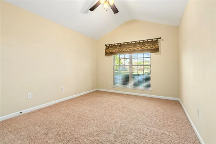 Vaulted ceilings and plush carpeting enhance this serene space with natural light.