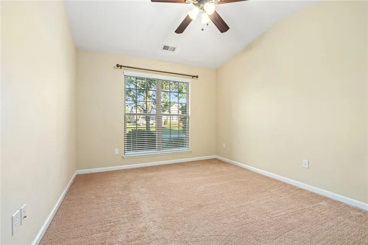 Vaulted ceilings and plush carpeting define this versatile interior space.