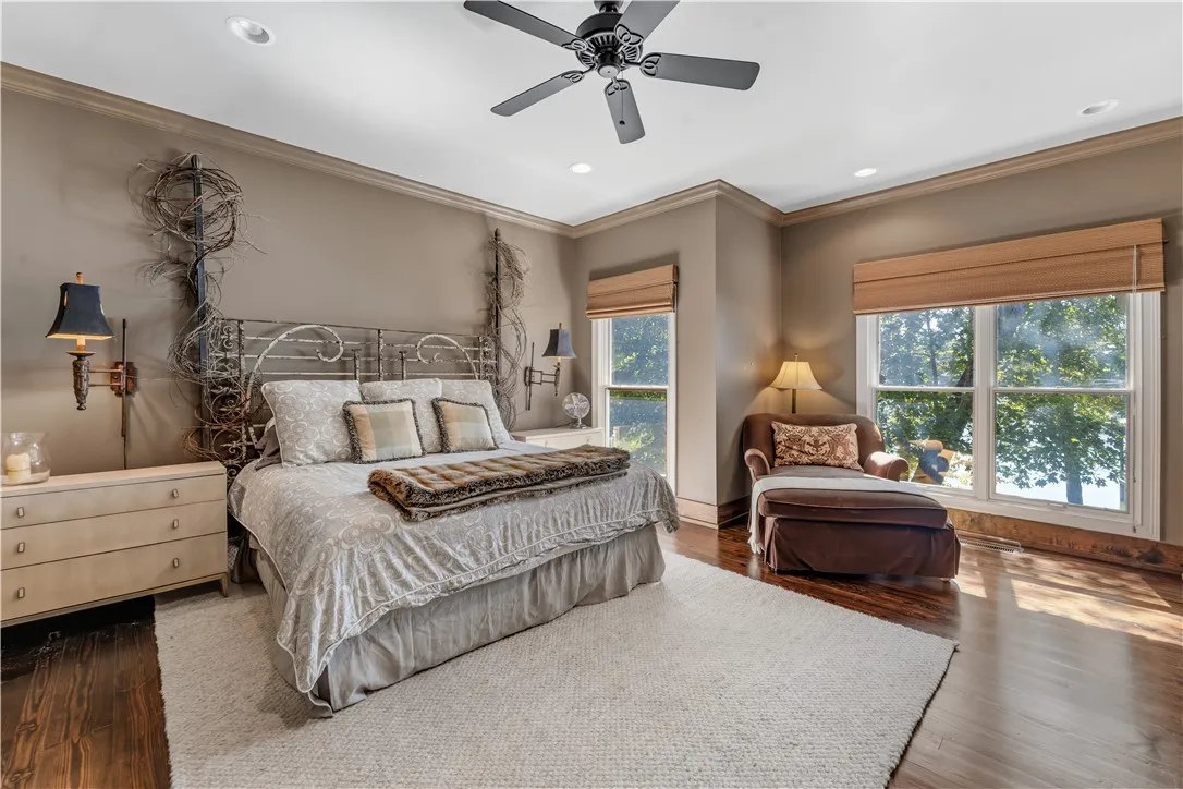 Gleaming hardwood floors and classic crown molding anchor this relaxing bedroom retreat.