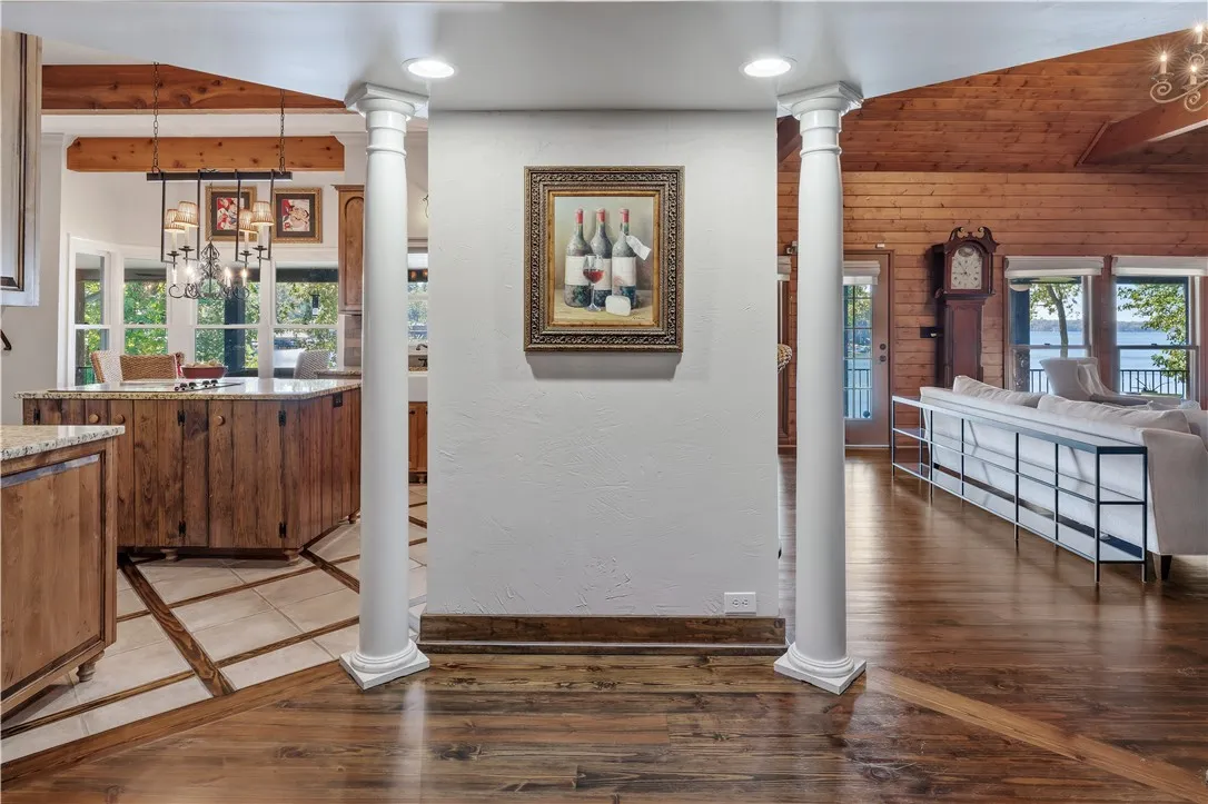 Gleaming hardwood floors and classic architectural columns frame views of the rustic, light-filled interiors.