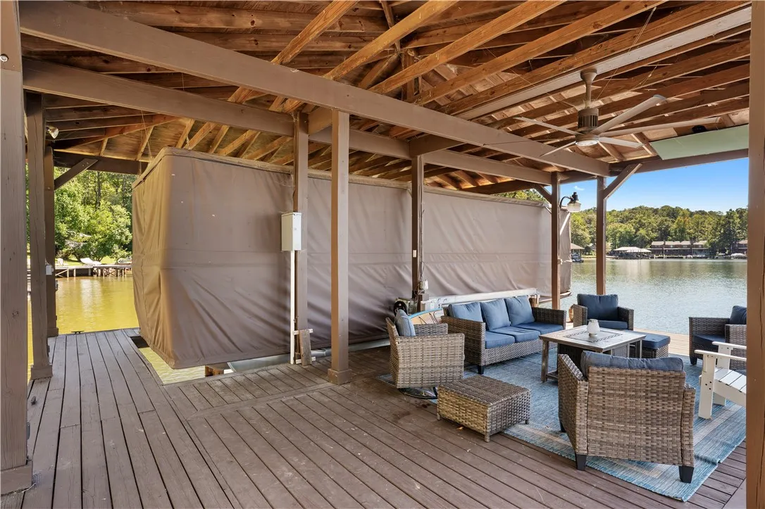 Sheltered by a vaulted wood ceiling, this spacious covered dock overlooks the peaceful water.