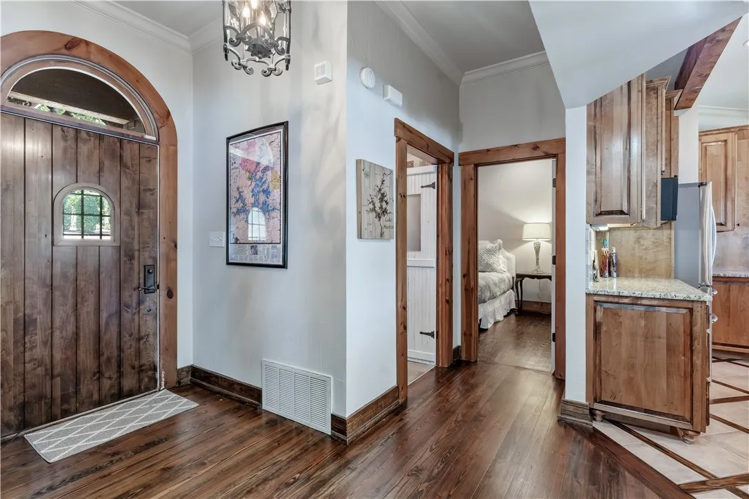 Rich hardwood floors and natural wood casing frame an inviting entrance foyer.