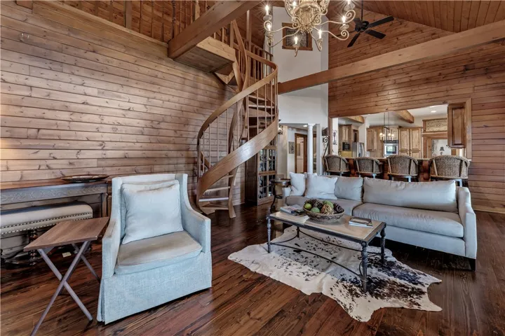 Rich wood planking and a striking spiral staircase define this rustic living area.