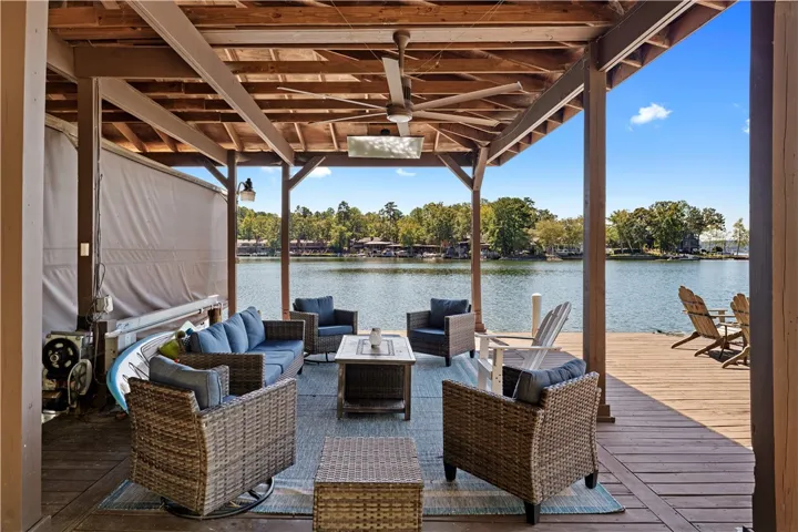 A spacious covered deck directly overlooks the water.