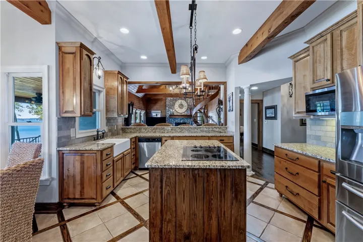 Exposed wood beams and granite countertops elevate this kitchen.