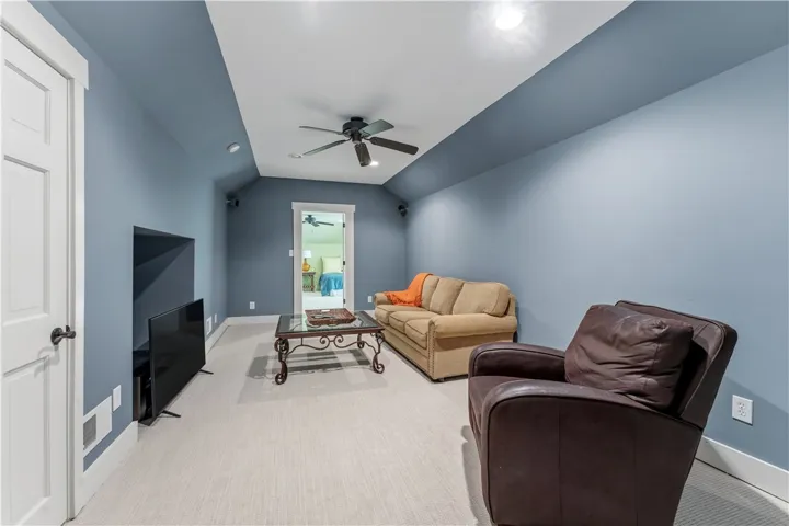 Carpeted flooring and angled ceilings define this versatile upper-level recreation space.