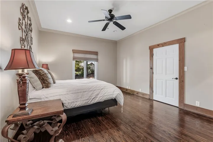 Gleaming hardwood floors and rustic wood trim accent this serene bedroom space.