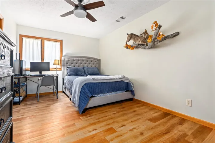 Warm wood floors and a wood-trimmed window anchor this comfortable space.
