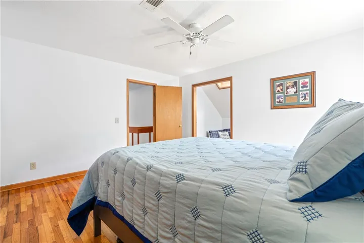 Gleaming hardwood floors and clean white walls define this comfortable second-floor bedroom.