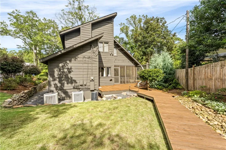 Angled wooden siding and a matching walkway define this contemporary exterior design.
