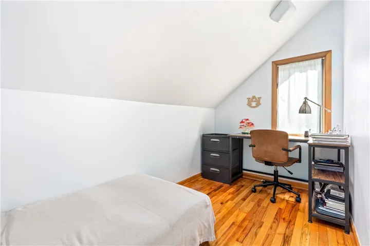 Slanted ceilings and warm wood floors define this cozy upper-level study space.