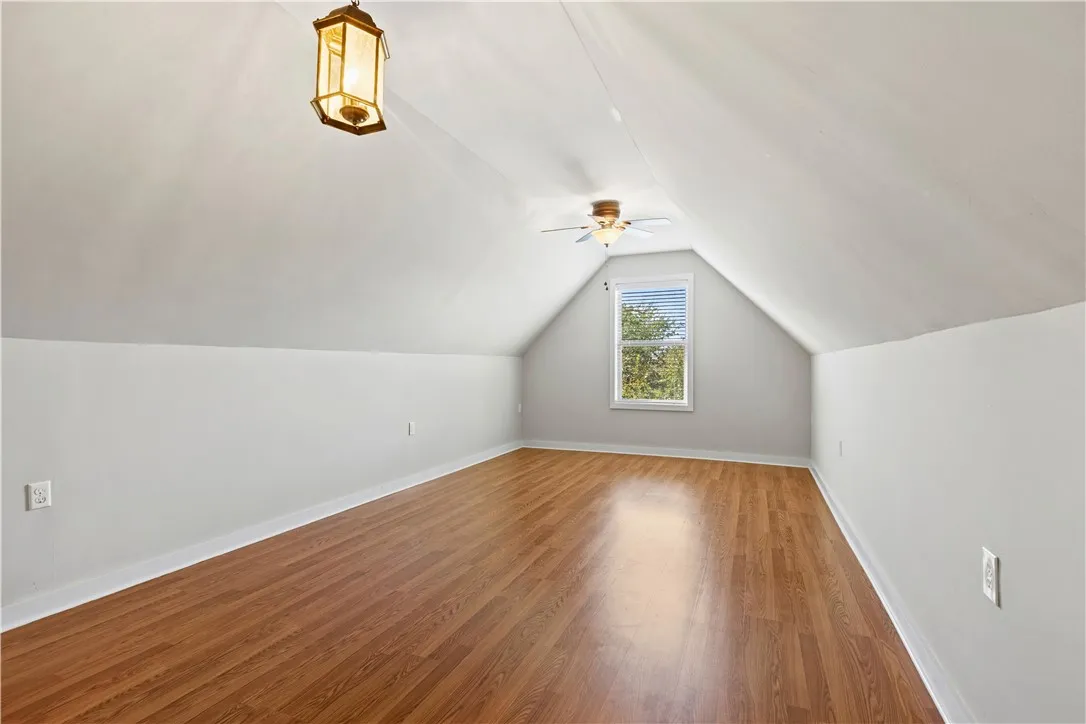 Sloped ceilings and rich wood floors define this versatile upper-level bonus space.