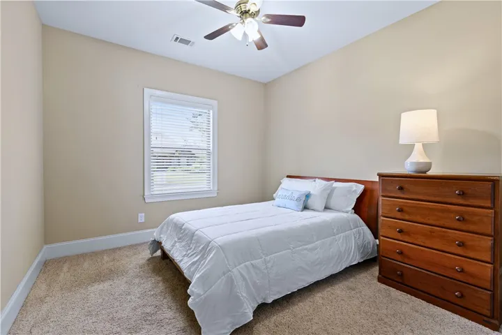 Carpeted flooring and a classic single window highlight this comfortable space.