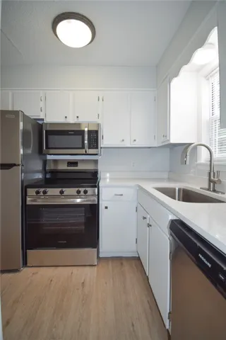 Gleaming stone countertops and stainless steel appliances maximize functionality in this kitchen.