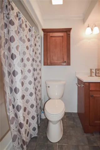 Rich wood cabinetry and classic tiling define this functional bathroom space.