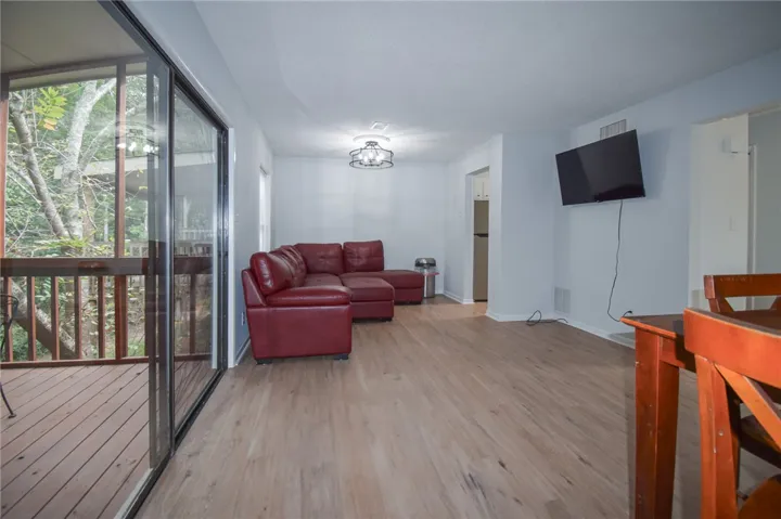 Sliding glass doors open directly to a private deck from the spacious living area.