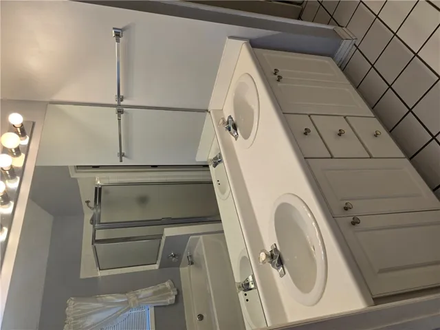 A spacious double vanity and a separate shower area define this classic bathroom.
