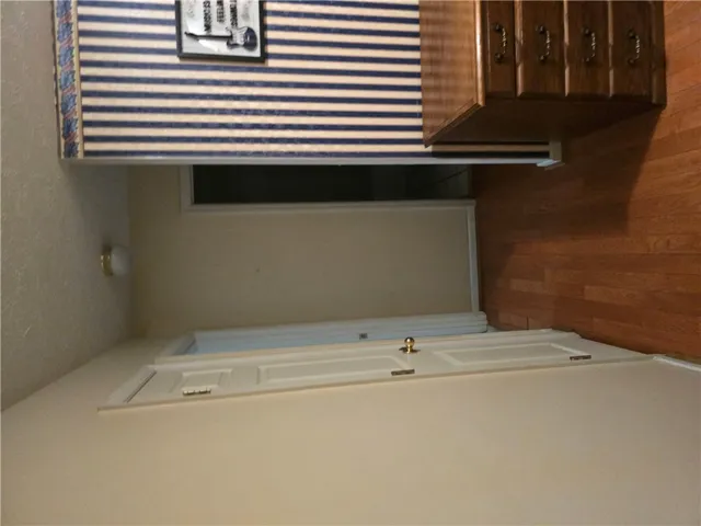 Warm hardwood floors connect transitions between living spaces and bedrooms.