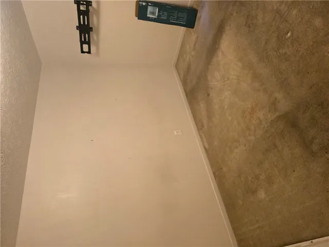 Carpeted flooring and textured plaster walls define this versatile interior space.