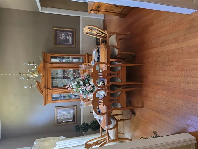 Gleaming hardwood floors and classic crown molding define this formal dining space.