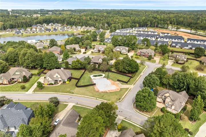 Lush green lawns and winding streets define this peaceful neighborhood from an elevated perspective.