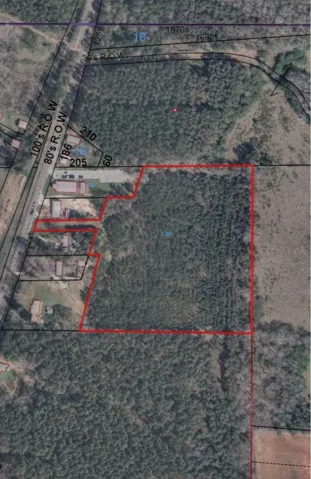 An aerial plat map outlines the expansive boundaries of this wooded acreage property.