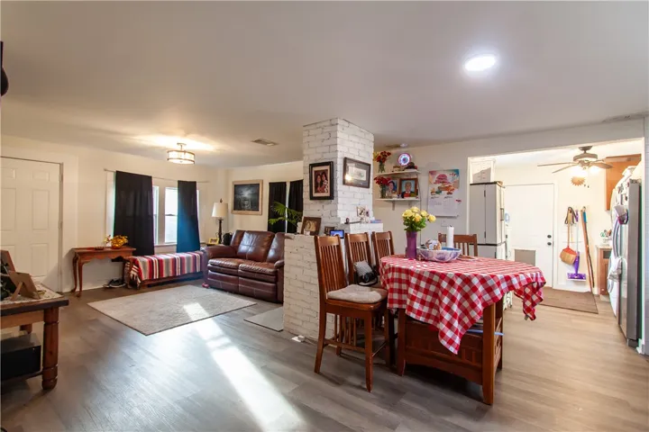 Sunlight streams across the wood-look flooring of this versatile living and dining area.