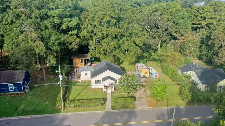 Mature trees frame a classic single-story home set on a generous suburban lot.
