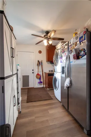Durable plank flooring and built-in cabinetry enhance this multi-functional utility space.