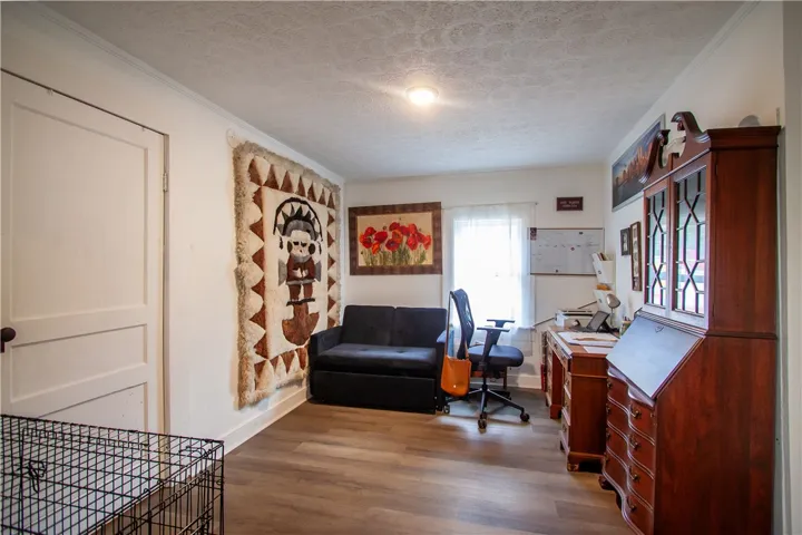 Smooth wood floors and classic crown molding define this versatile home office workspace.