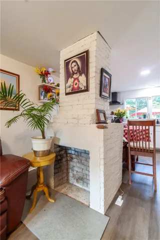 A painted brick fireplace serves as a central focal point in this open floor plan.