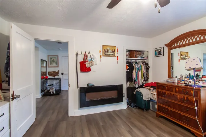 Warm wood-look flooring and an electric fireplace enrich this comfortable private retreat.