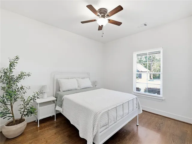 Rich hardwood flooring anchors this inviting space, complete with a classic multi-lite sash window.