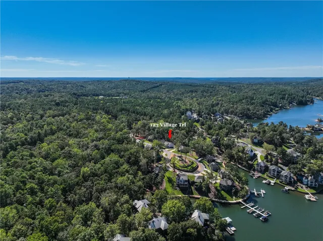 Lush woodland surroundings border the serene shoreline of this lakeside neighborhood.