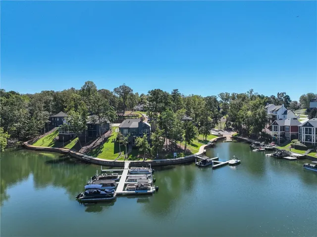 Lush green lawns and tall trees surround private docks along this scenic deep water cove.