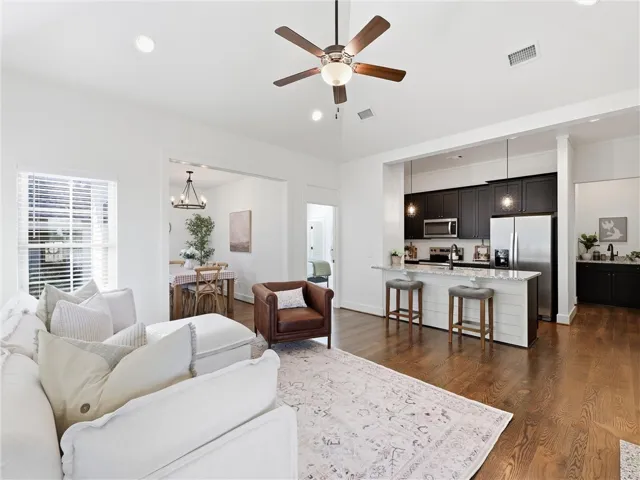 Hardwood floors and recessed lighting flow through this bright, open main-level living space.