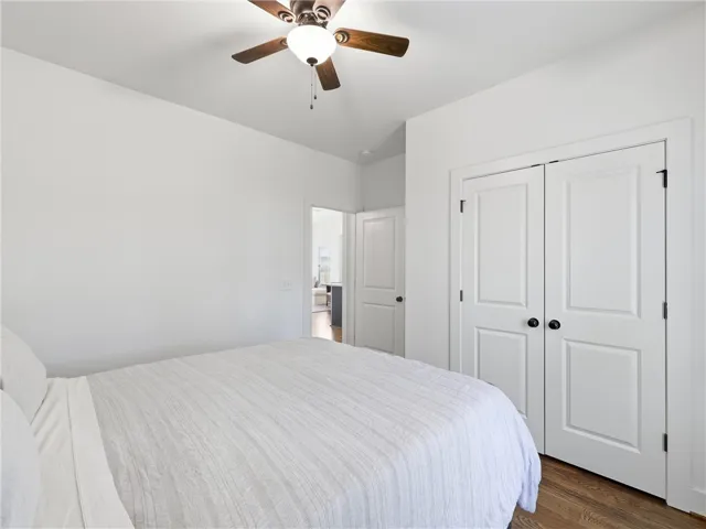 Rich hardwood flooring pairs beautifully with clean white walls and structured molding details.