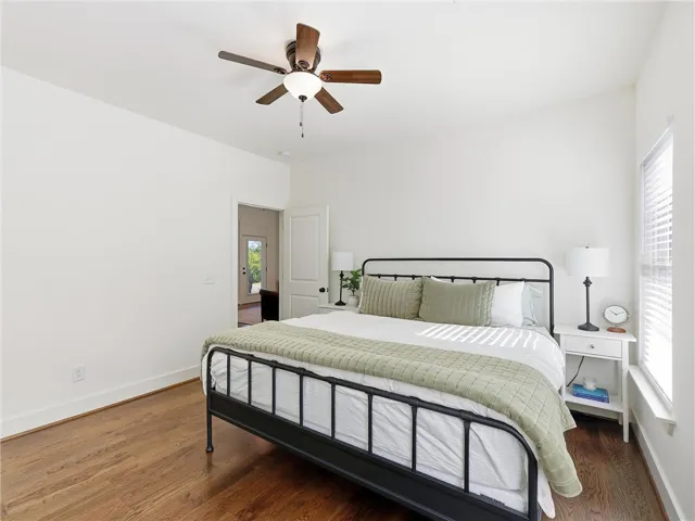 Rich hardwood flooring anchors this inviting space, complete with a classic multi-lite window.
