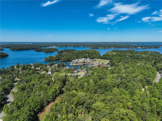 Lush green forests envelope this lakeside property situated along the sparkling waterfront.