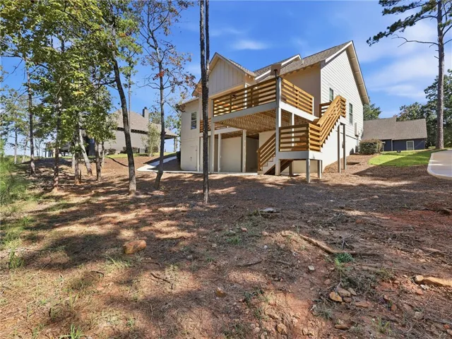 A spacious wooden deck elevates this modern multi-level home nestled among mature trees.