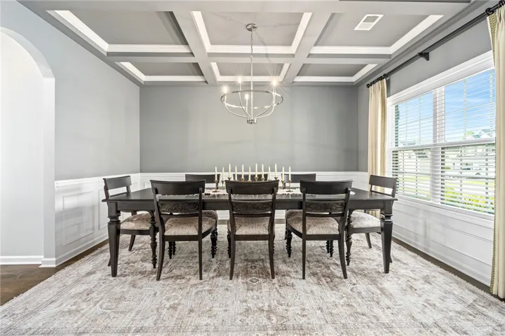 Elegant coffered ceilings and classic wainscoting define this formal dining space.