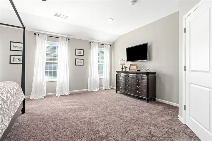 Plush carpeting and vaulted ceilings enhance this comfortable bedroom retreat.