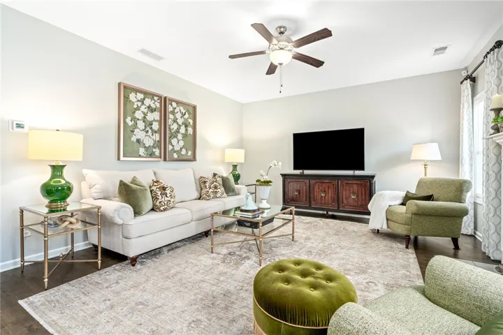 Gleaming hardwood floors and a warm fireplace highlight this comfortable and inviting living area.