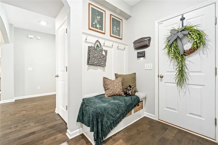 Rich hardwood flooring guides visitors from the front door into a classic, welcoming foyer.