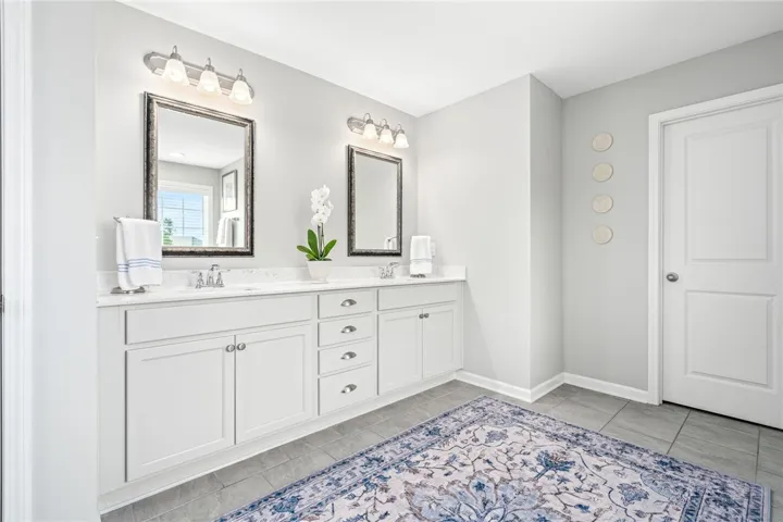 Clean lines and a spacious dual vanity define this modern bathroom space.