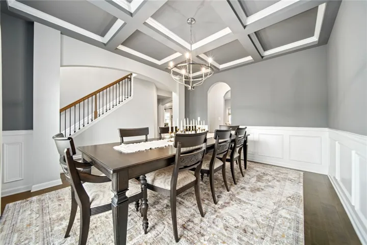 Elegant coffered ceilings and classic wainscoting define this formal dining space.