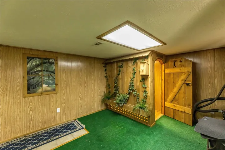 Warm wood paneling and a large overhead skylight define this unique interior space.